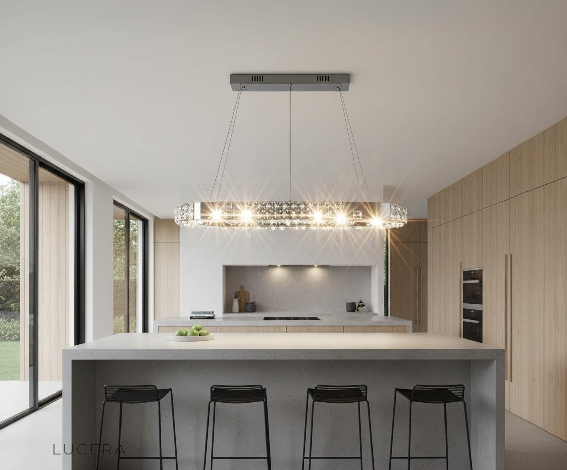 Skald oval LED chandelier with chrome finish in bright open-concept kitchen and island