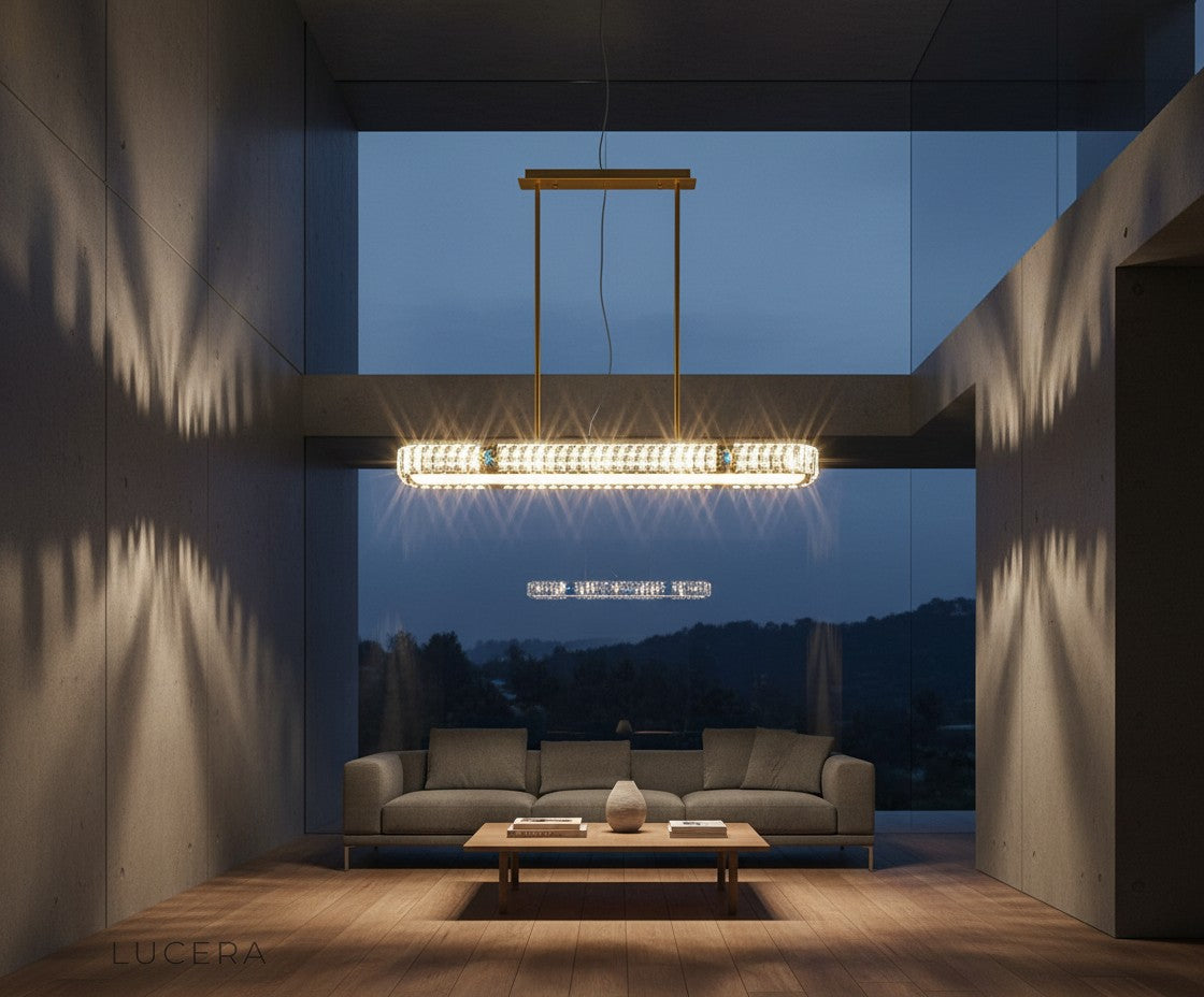 nighttime lifestyle shot of Frej pendant chandelier glowing above a stylish bar counter with copper accents