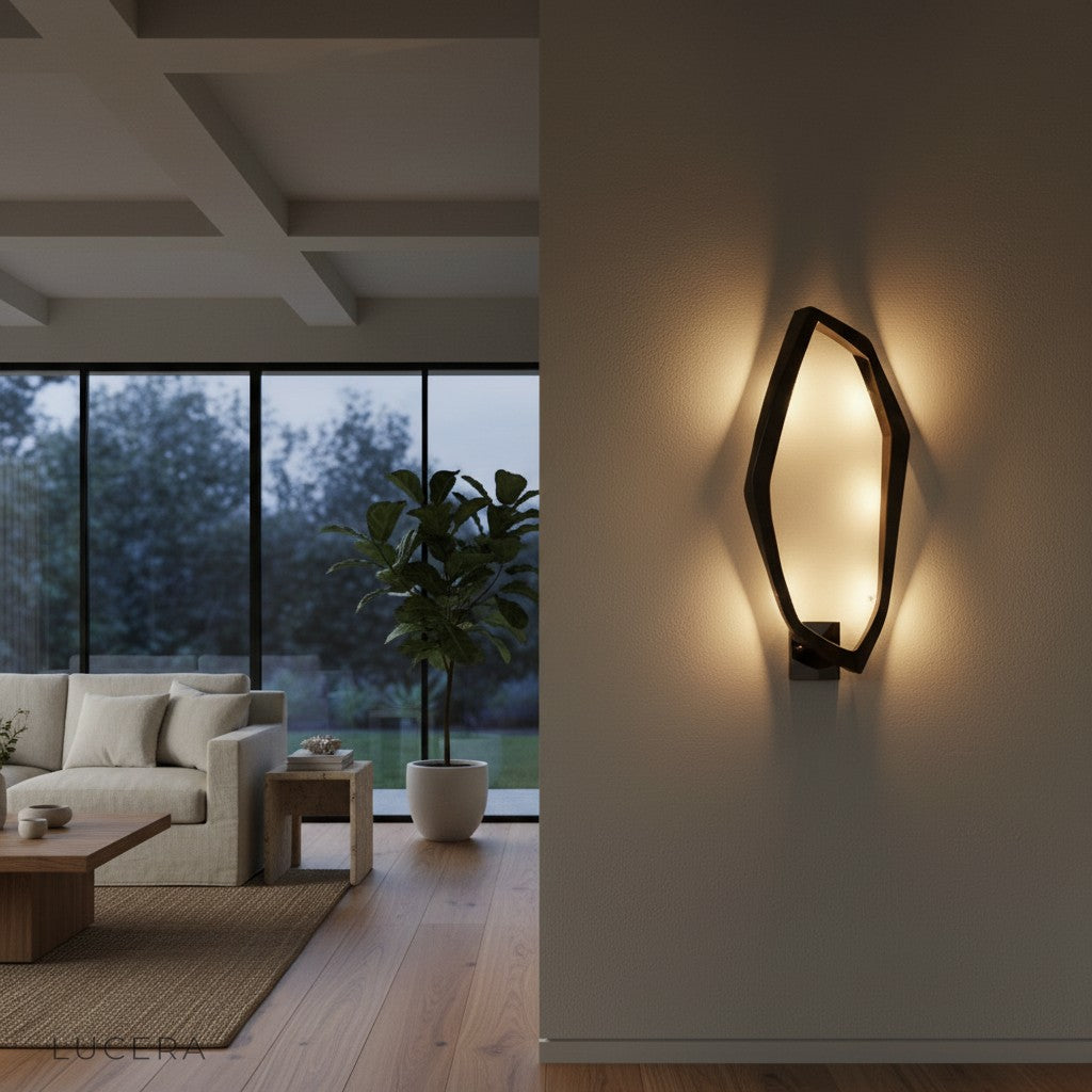 Brushed steel LED lamp glowing in a dark modern room with soft shadows