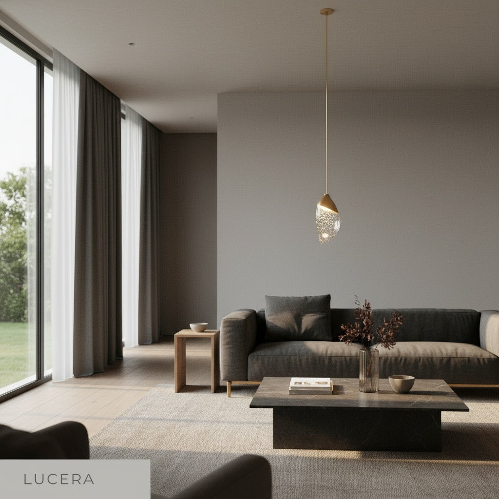 sculptural Font pendant light illuminated at night beside a bedside table