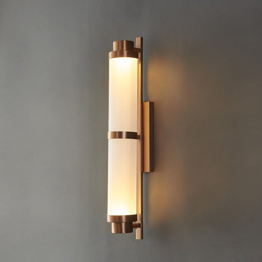 Studio shot of Parapet wall sconce front view, gold metal frame and clear glass shade on neutral background
