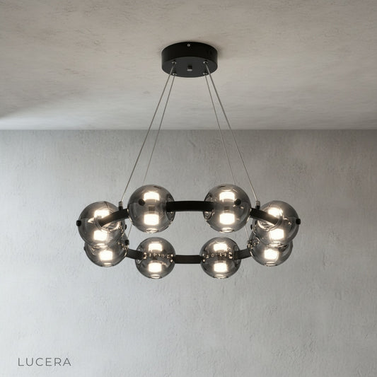 Studio shot of Jive Round Chandelier with circular aluminum frame and clear glass globes