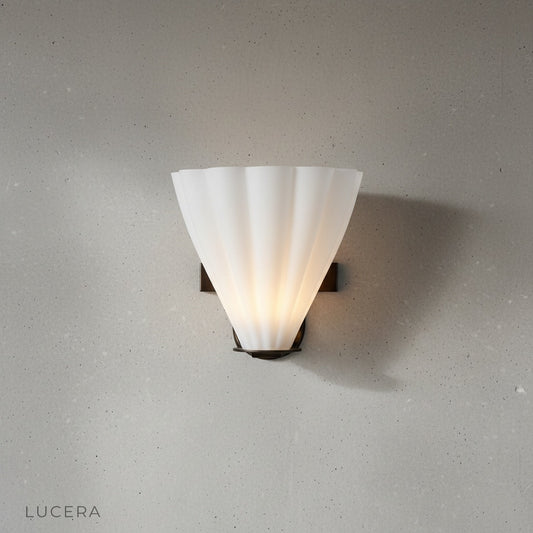 Studio shot of Jagged Ferrous wall lamp showing smooth glass and metal support