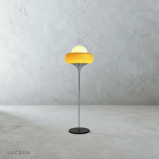 Studio shot of black floor lamp with hand-crafted glass shade on clean white background
