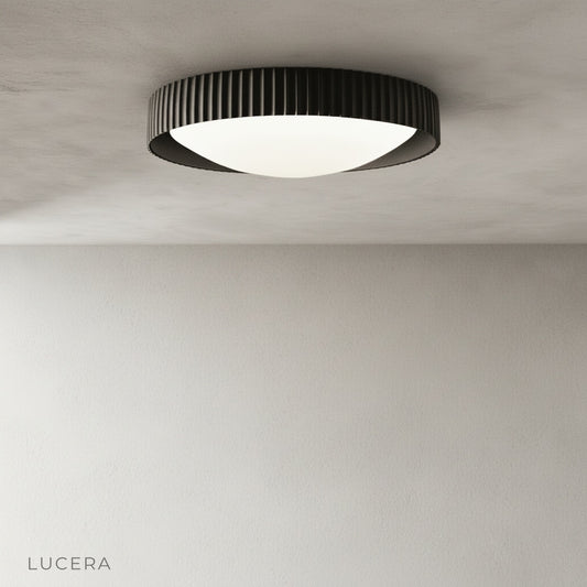 Minimalist Wafers ceiling light on clean white background showing textured exterior