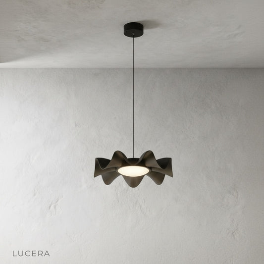 front view of silvery pendant light hanging from ceiling on clean white background