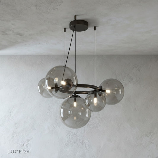 Grenache chandelier studio view showing circular metal frame and glass globes