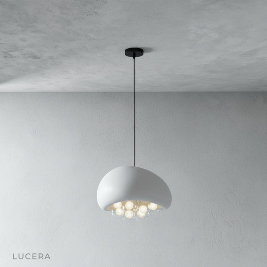 studio shot of resin dome pendant light with illuminated globe cluster