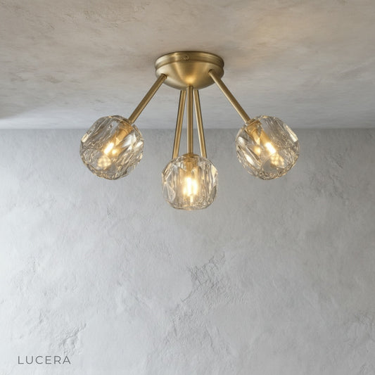 Crylo ceiling light brass arms and crystal shades studio angle view