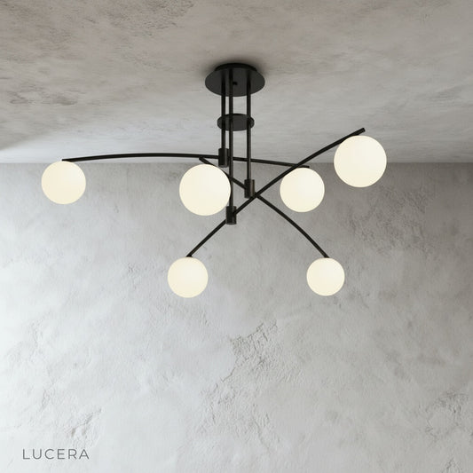 minimalist studio view of Yonder ceiling lamp angled from below highlighting asymmetrical arm composition