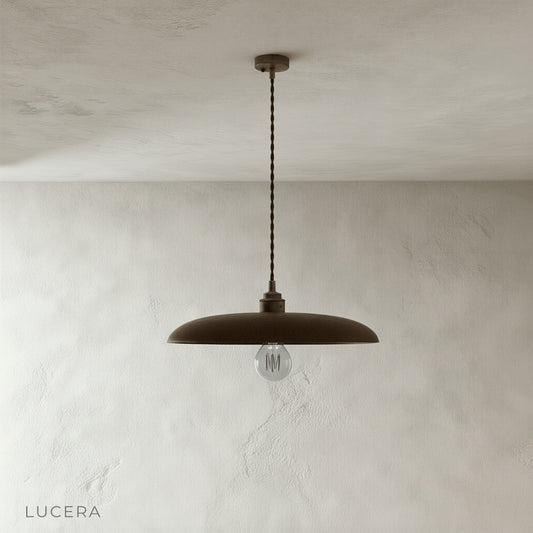 Minimalist wood pendant light with brass accents on clean studio background