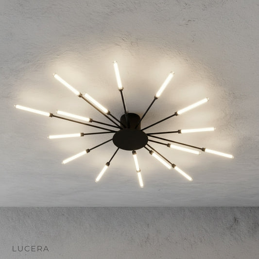 close-up of Karma chandelier LED bulbs and brushed metal connectors against dark backdrop