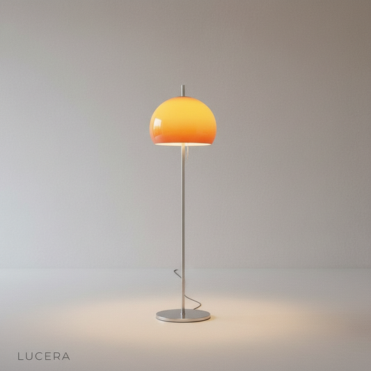 studio shot of Warden floor lamp with chromed metal body and dome glass shade