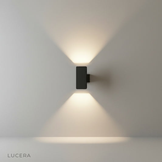 minimalist aluminum wall lamp mounted on a neutral stucco wall in a studio setting
