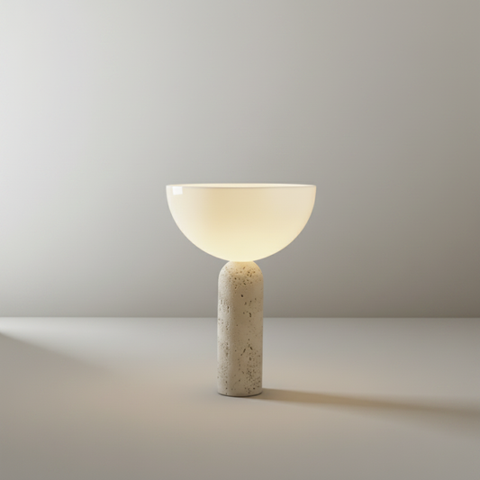 Studio shot of Tristan Table Lamp front view showing travertine base and clear glass dome