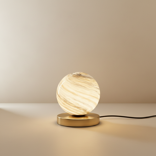 Studio shot of Jewel Table Lamp front view showing circular marbled glass shade and brass stem