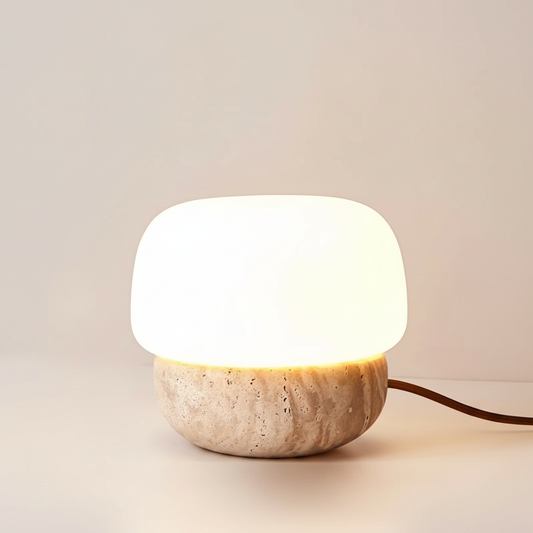 Studio shot of Jut Table Lamp with rounded glass diffuser on natural stone base