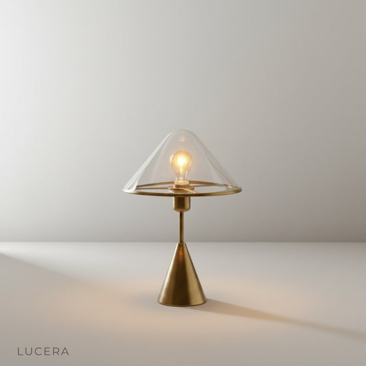 Studio shot of manganese blue conical base lamp with transparent glass shade