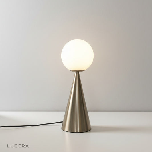 studio shot of hieroglyph table lamp with golden glass cone on white background