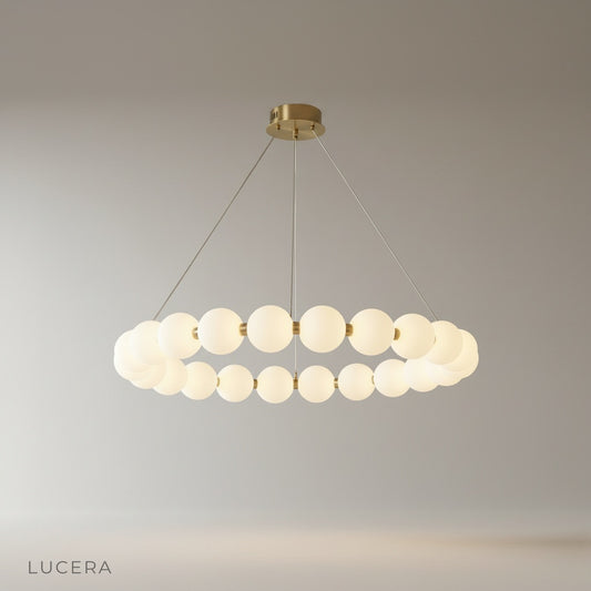 Studio shot of Ignite chandelier with pearlescent spherical shades on clean white background