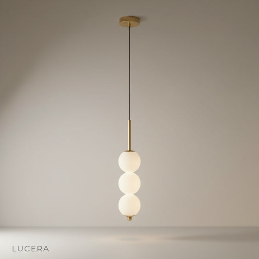 studio shot of Meridian Pendant Light with three glass ball shades on clean white background