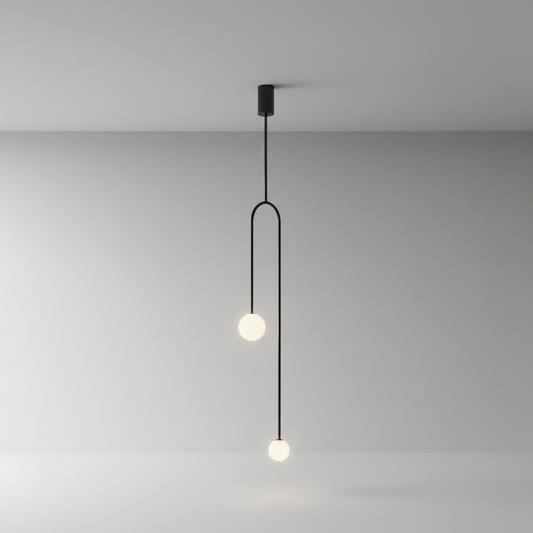 studio shot of Vesuvianite pendant light showing dual frosted glass globes on black arched iron frame