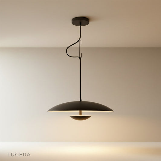 Studio shot of the black dome-shaped Cinder Pendant Light against a clean white background