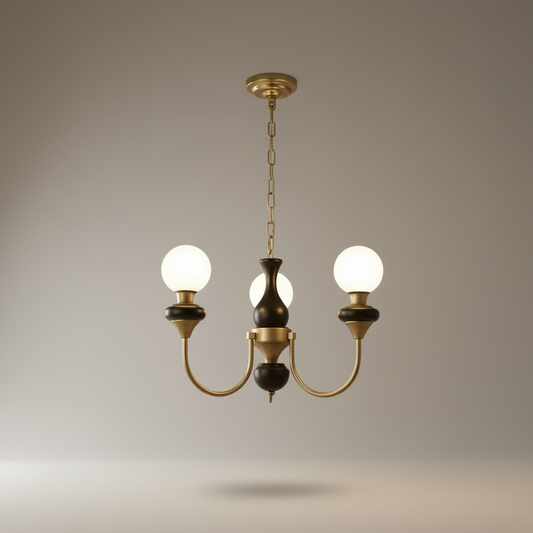 Studio shot of Flora Chandelier with frosted globe shades and curved brass-finished arms