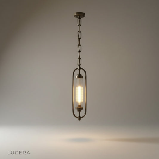 studio shot of Zigzag Lucis pendant lamp with oval brass frame and fluted glass shade