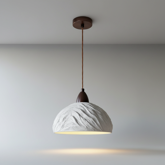 Minimalist cement pendant lamp on clean white studio background, front view showing raw texture