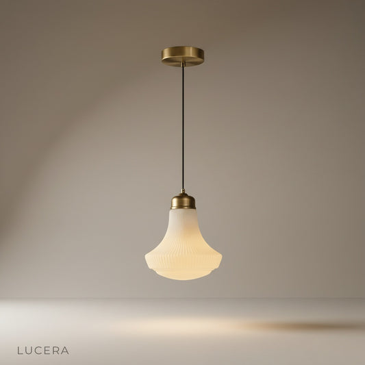 studio shot of brass Chianti pendant light with bell-shaped glass shade on neutral background