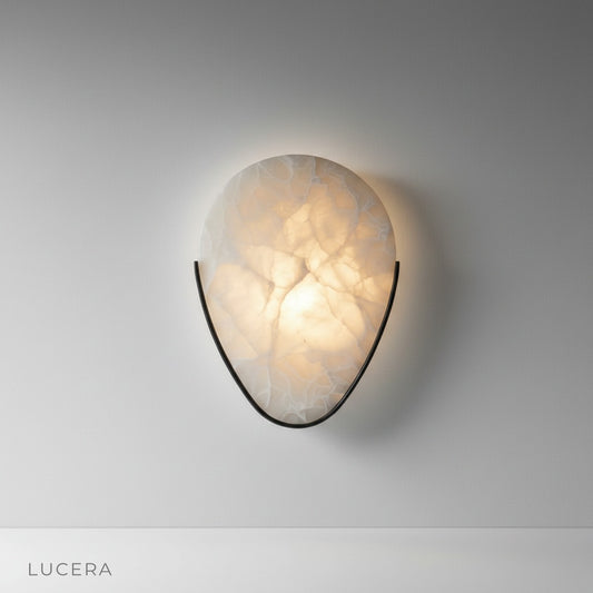 Studio shot of Lucera Borealis wall sconce with translucent alabaster shade and metal frame