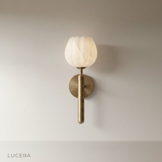studio shot of the Madeira wall lamp with sculptural alabaster shade and solid copper structure