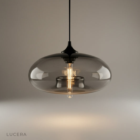 Studio shot of Oswin Pendant Light with clear glass shade and matte black holder
