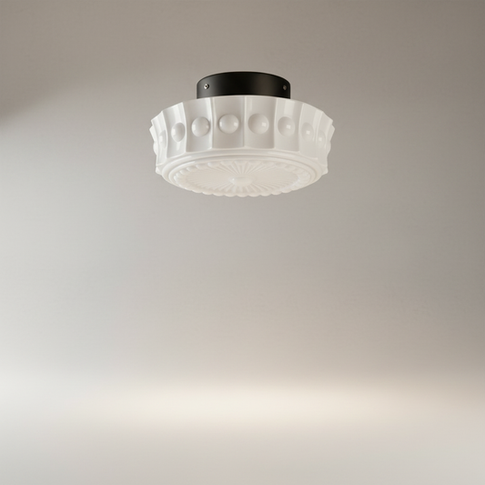 studio shot of Xystus flush mount light with embossed radial pattern and beaded trim