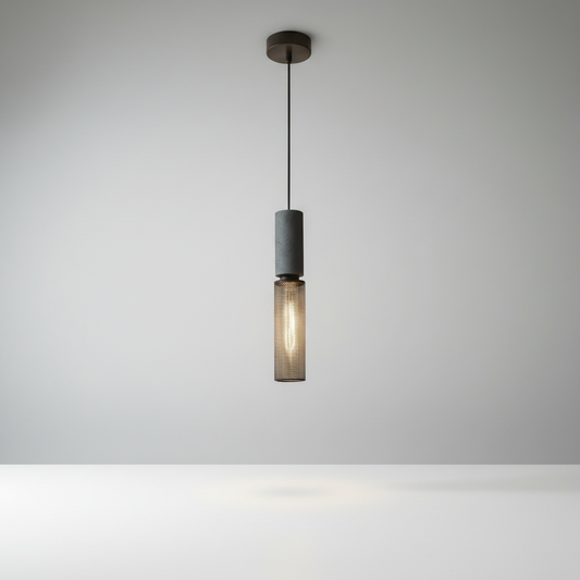 Studio shot of Ridge Pendant Light showing cylindrical stone and iron body with perforated black mesh finish