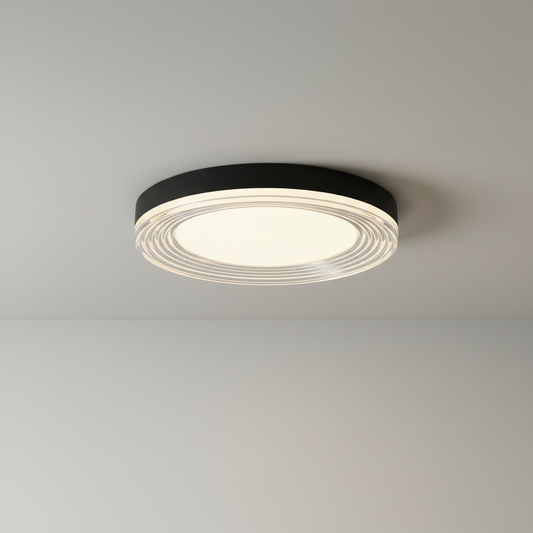 studio shot of round black ceiling light with layered acrylic rings front view