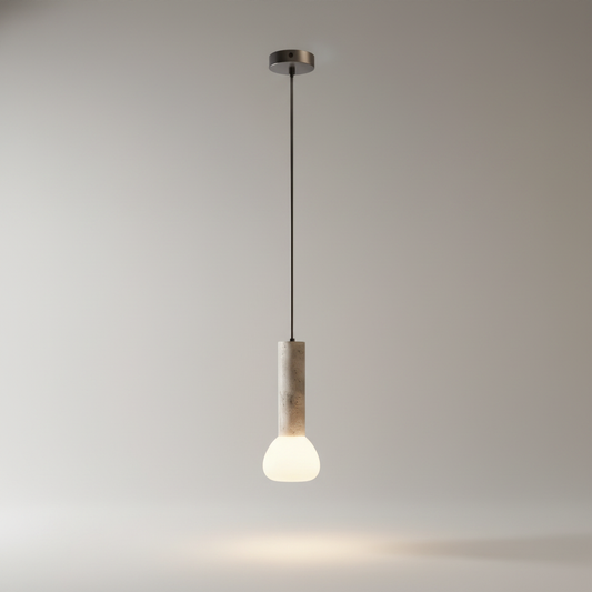 studio shot of cylindrical travertine pendant light with minimalist metal suspension