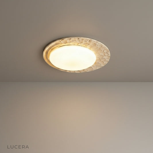 studio shot of obsess ceiling lamp with natural travertine base and marble shade