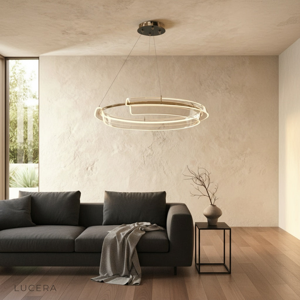 dual-ring LED chandelier casting warm ambient light in minimalist bedroom
