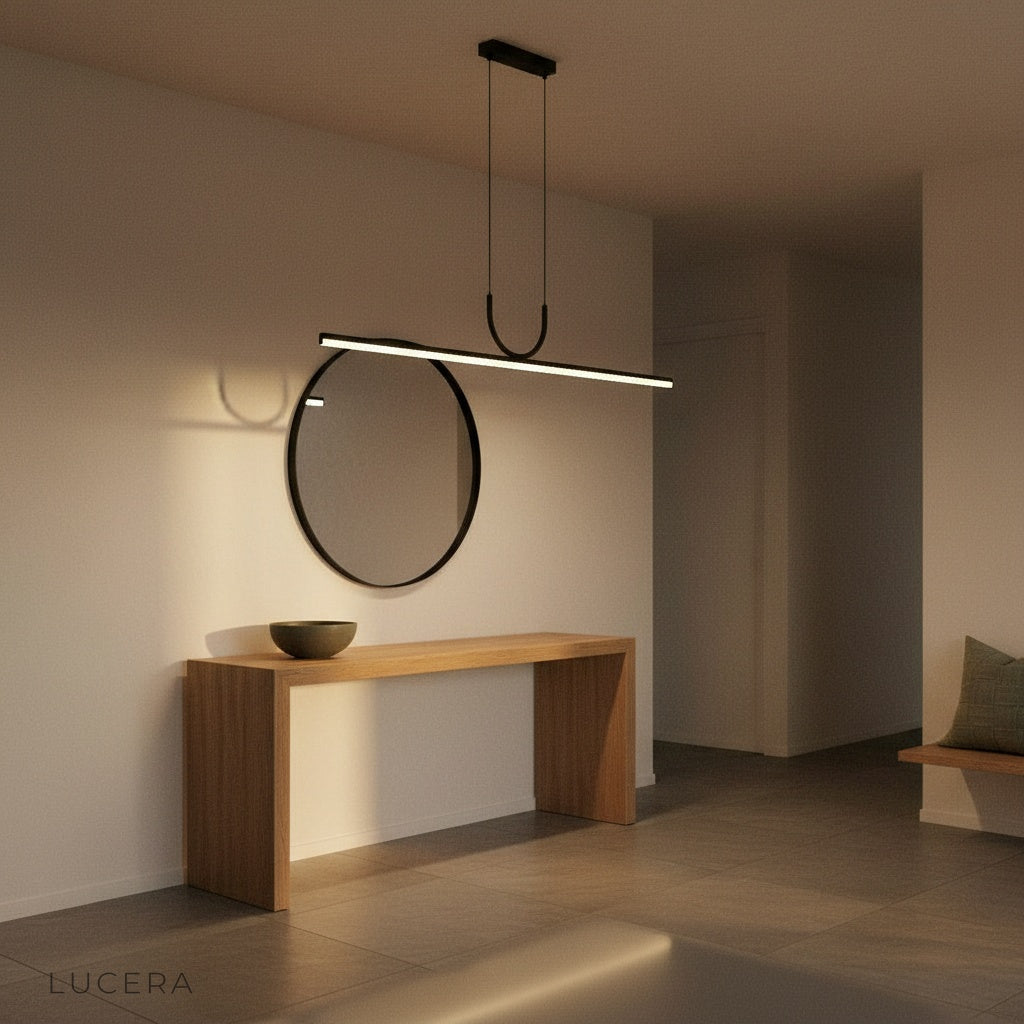 Nighttime lifestyle shot of Honeysuckle pendant light glowing softly in a cozy dining nook with dark walls