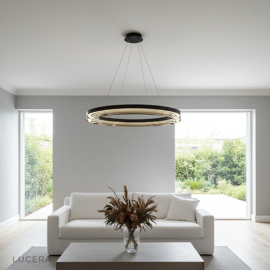 Dramatic low-angle shot of Vortex Ring Chandelier against dark ceiling with soft halo lighting