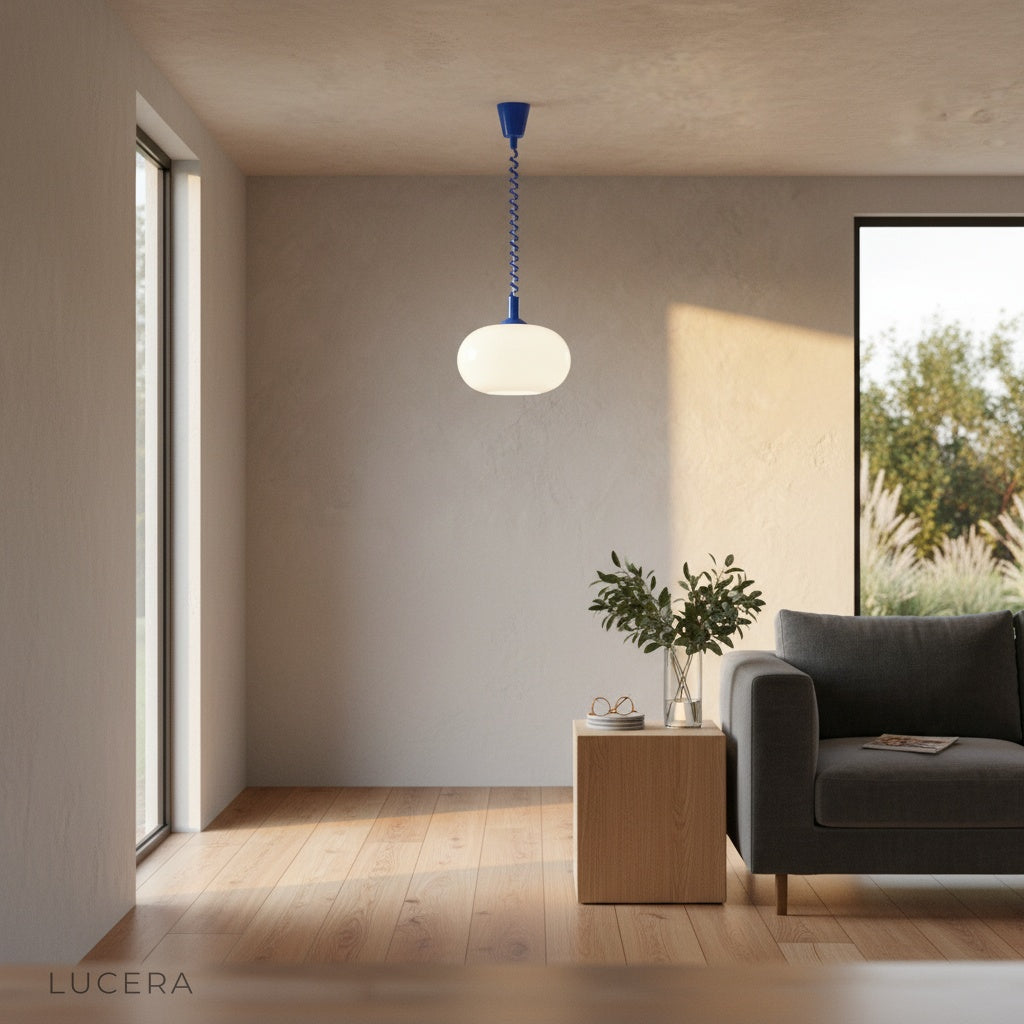 Xanthous pendant light in hallway with opal glass glowing against dark wall