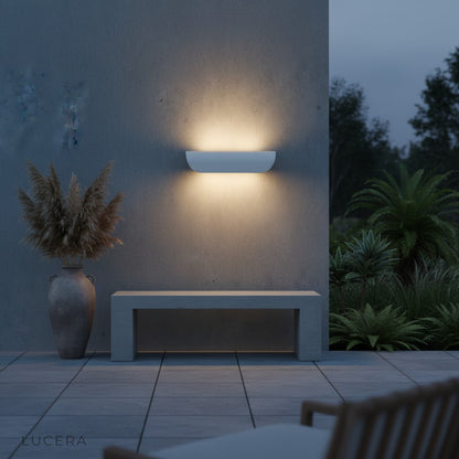 Vega sconce paired with wooden bench on a modern porch setting