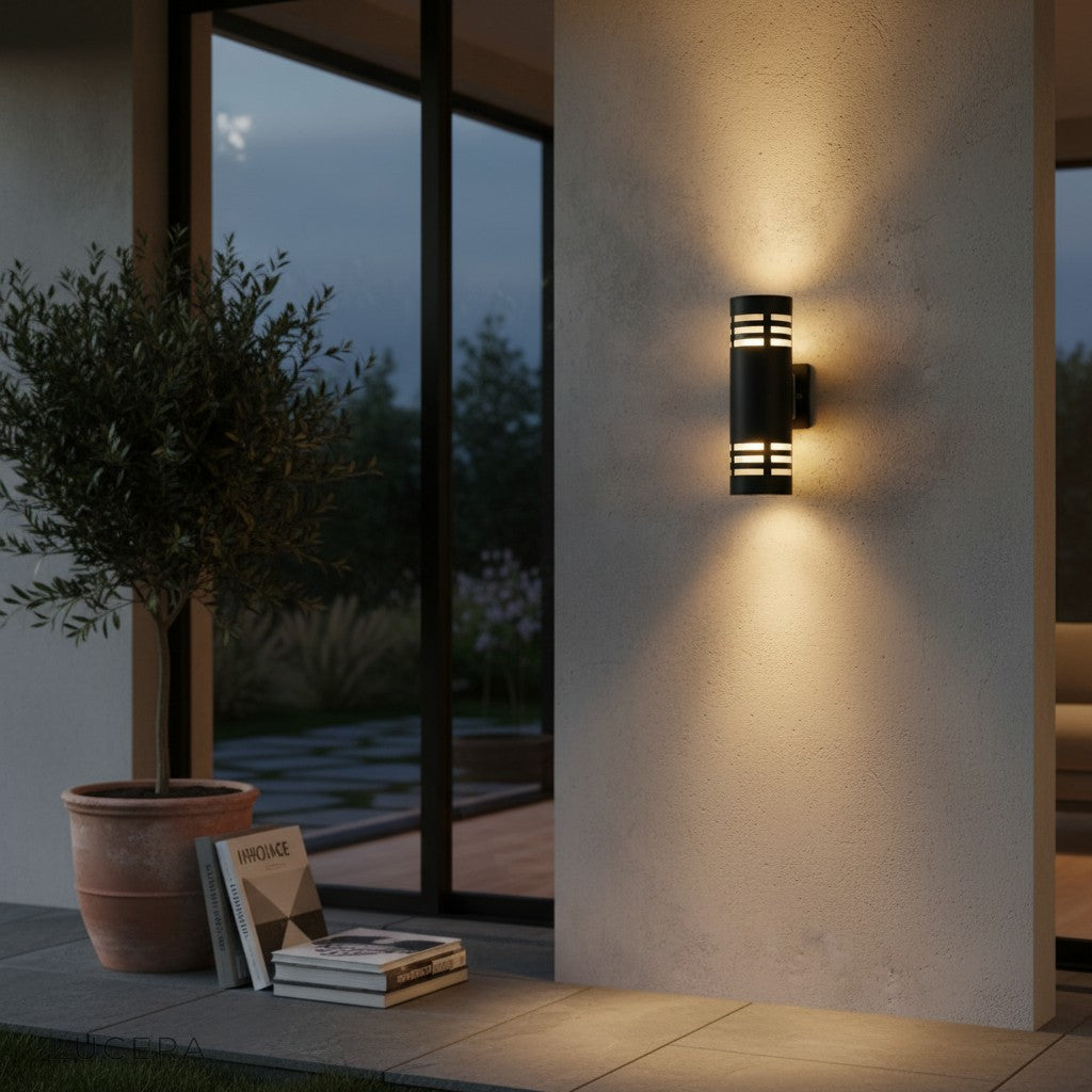 two Cleo sconces flanking a wooden garage door in warm glow
