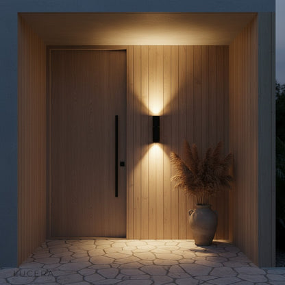 Canopus dual beam light in a covered outdoor lounge area with cozy seating and plants