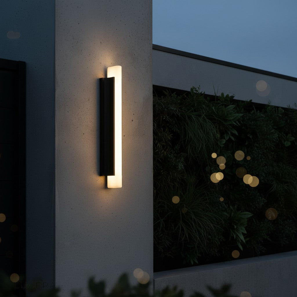 Corvus wall light in nighttime ambiance casting soft light on brick exterior