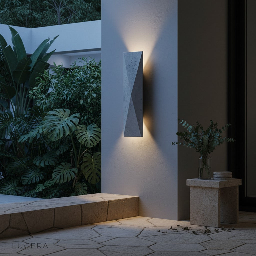 Outdoor travertine sconce illuminating a cozy seating area with warm shadows