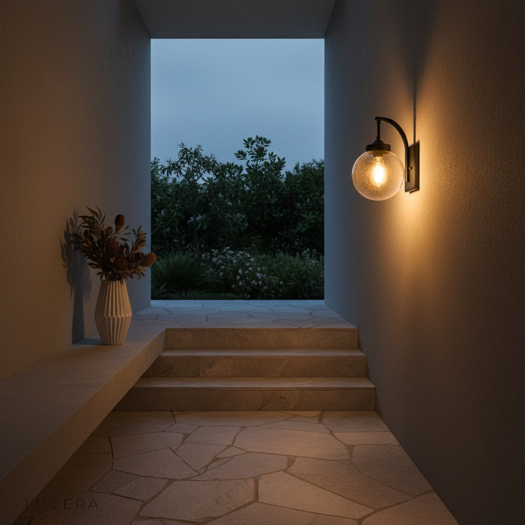 Nyx glass wall light casting warm glow on Scandinavian-style wooden deck