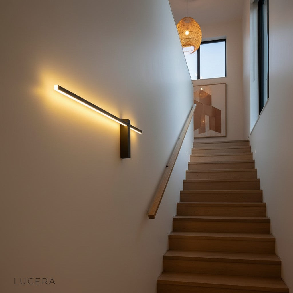 Aether sconce in matte black finish mounted on textured concrete wall
